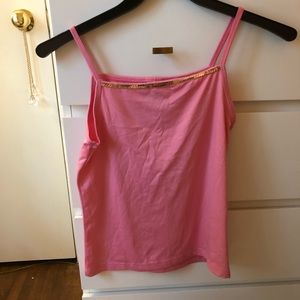 Spaghetti strap shirt with a gold design.